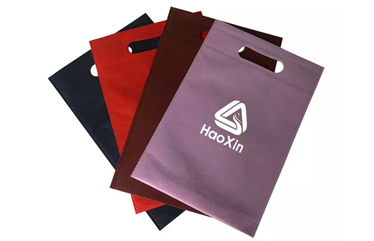 Automatic machine manufactured die cut handle non woven bag